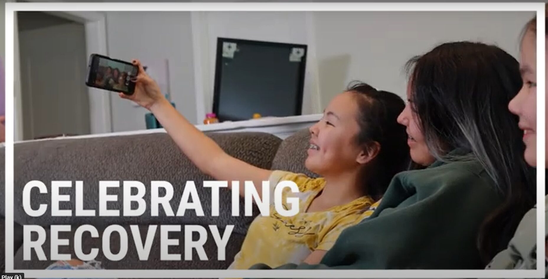video screen shot of teen siblings taking selfie